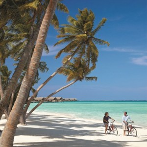 Couple cycling on the beach